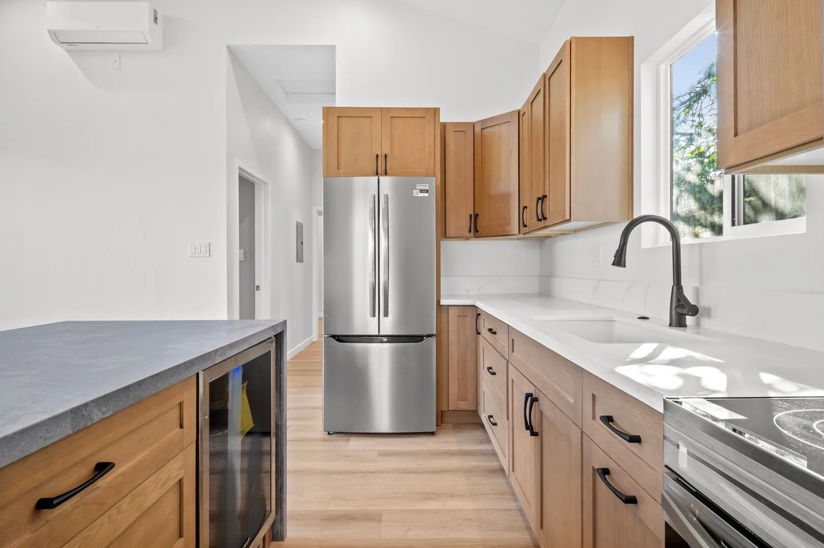 ADU galley kitchen with wood shaker cabinets, stainless French-door refrigerator, quartz counters and beverage fridge