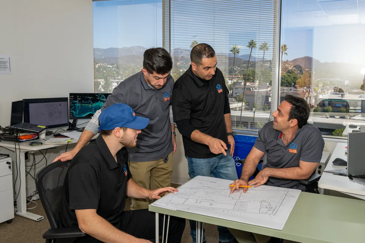Team reviewing ADU floor plans together