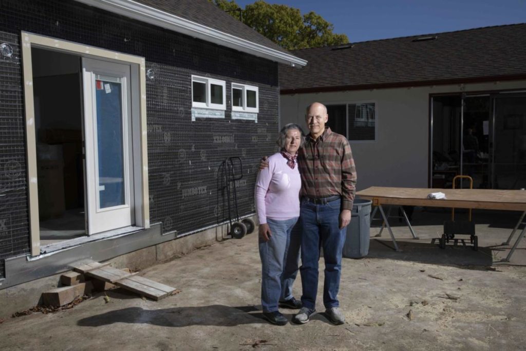 Paul and Rosa Boehm outside the Accessory Dwelling Unit they’re building in the backyard of their west San Jose home. Paul and Rosa are considering downsizing into the ADU. (Photo by Sean Havey for CalMatters)